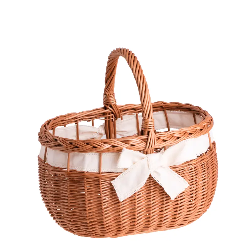 Winalia wicker shopping basket with cream trim, handle, and bow TheWickerStories